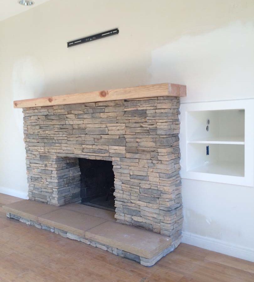 New stone veneer over the existing fireplace to create a vintage theme for the home. Pacificland Constructors