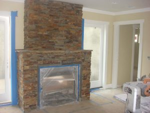 New stone veneer was placed on the exterior of the chimney by our masons to create a vintage theme for the living room. Pacificland Constructors