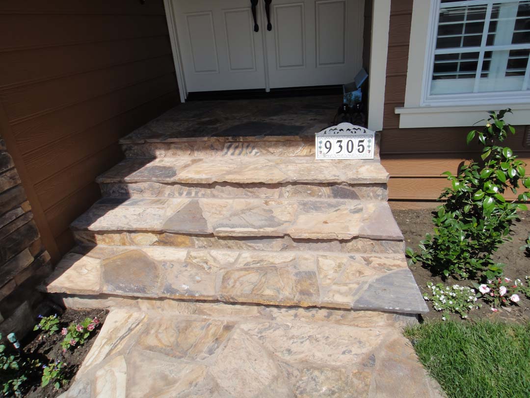 Stone Veneer Contractor Masonry Concrete Block Pavers New Stone Flagstone Was Placed On The Front Yard Entrance Steps Of Home