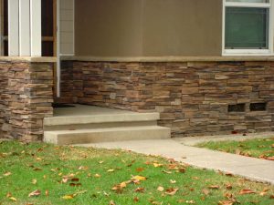Completed Coronado stone veneer on the exterior wall of the home. Pacificland Constructors