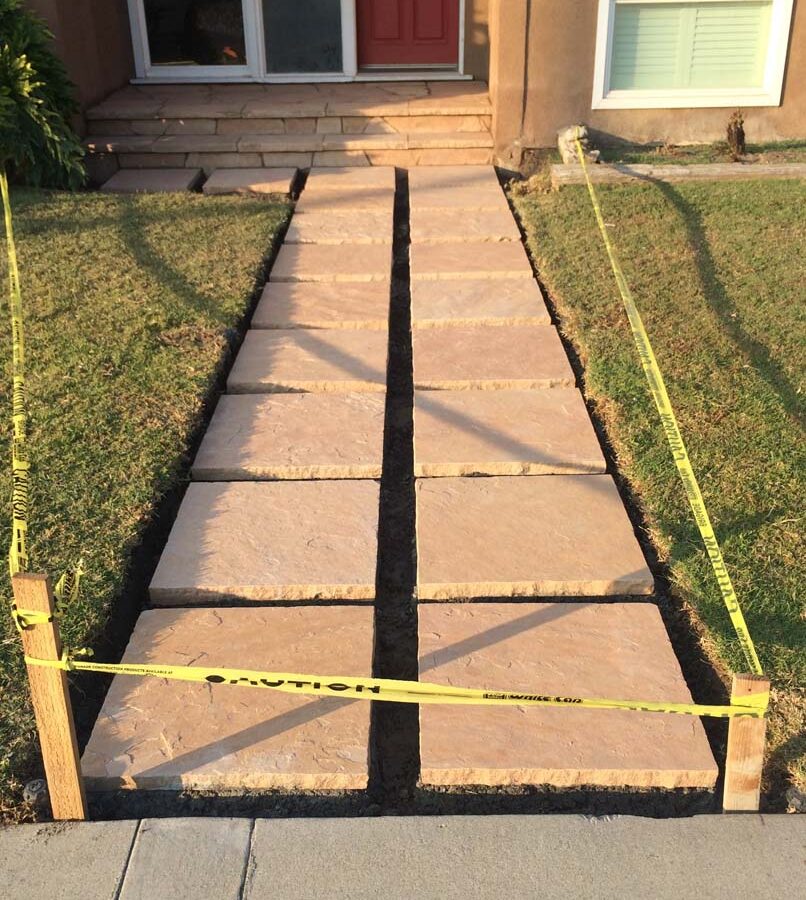 Custom stone cut slabs used as a walkway for a home’s entrance. Pacificland Constructors