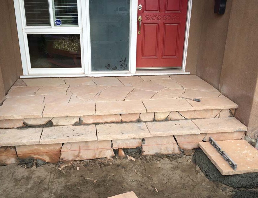 Custom stone cut slabs used as a walkway for a home’s entrance. Pacificland Constructors