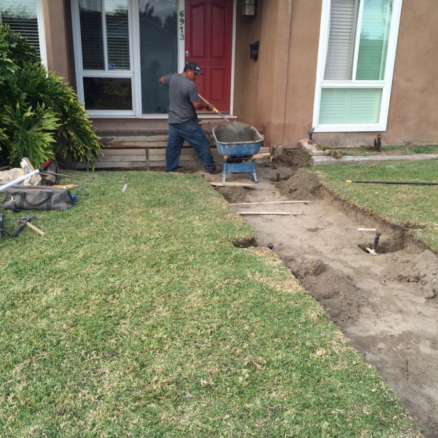 Construction of custom stone cut slabs used as a walkway for a home’s entrance. Pacificland Constructors