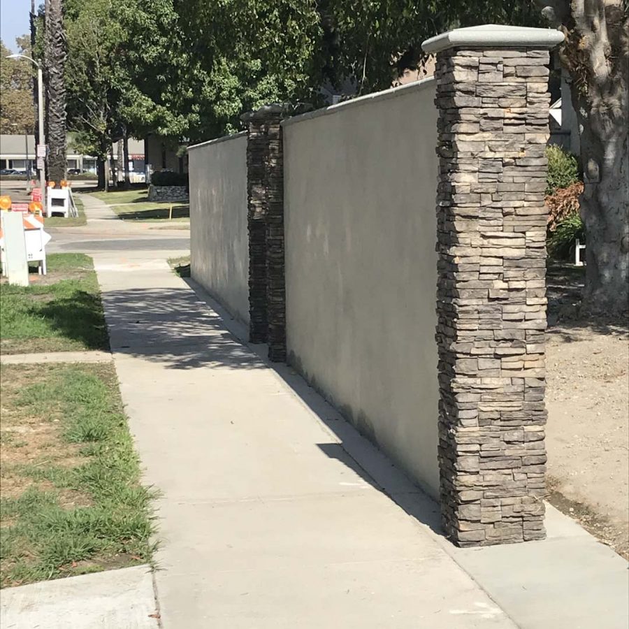 CMU wall with smooth cream white stucco finish. Pacificland Constructors