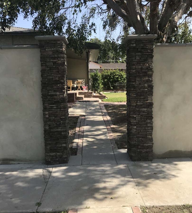 Front entrance to the yard. Finished Pilasters with stone veneer topped off with stepstone caps. Pacificland Constructors