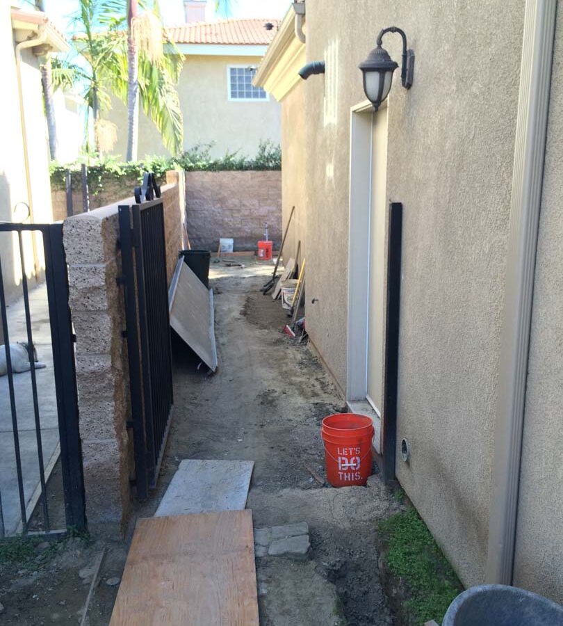 Construction of new colored stamped concrete for a backyard in Bellflower, CA. Pacificland Constructors