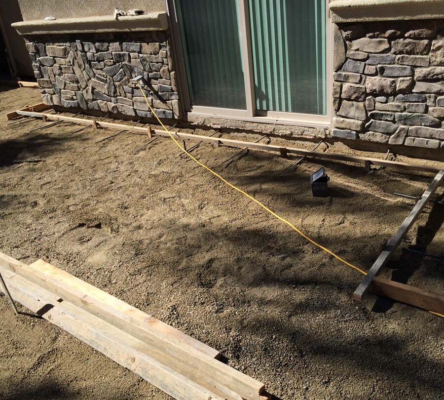 Grading and formwork construction for a new colored stamped concrete backyard in Bellflower, CA. We installed a drainage system throughout the backyard for optimal draining. Pacificland Constructors