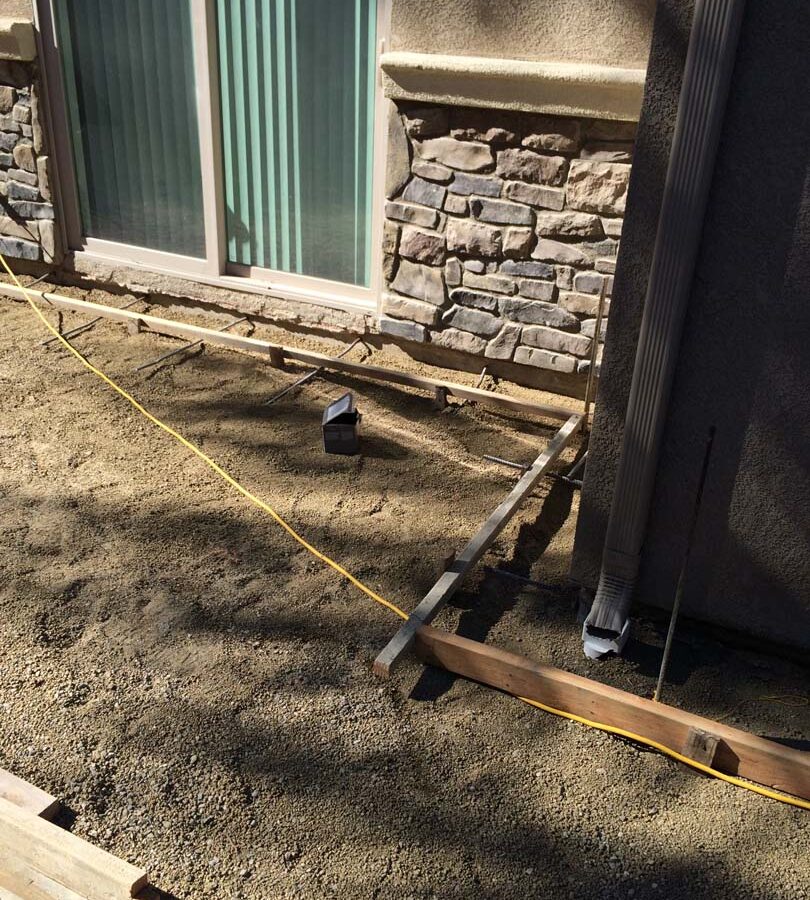 Grading and formwork construction for a new colored stamped concrete backyard in Bellflower, CA. We installed a drainage system throughout the backyard for optimal draining. Pacificland Constructors