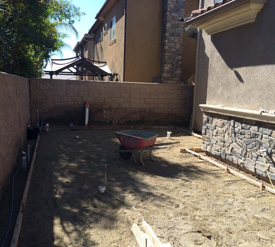 Grading and formwork construction for a new colored stamped concrete backyard in Bellflower, CA. We installed a drainage system throughout the backyard for optimal draining. Pacificland Constructors