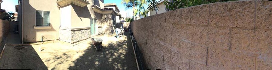 Panoramic view of the construction for a new colored stamped concrete backyard in Bellflower, CA. Pacificland Constructors