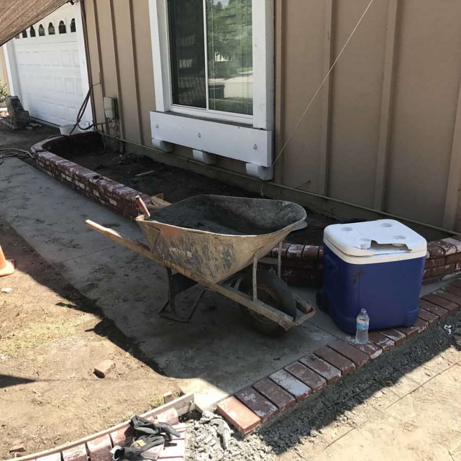 Construction of a new front yard concrete walkway with brick ribbons. Pacificland Constructors