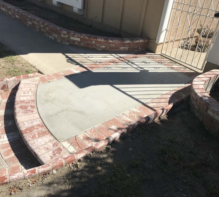 New front yard concrete walkway with brick ribbons and new brick planters. Pacificland Constructors