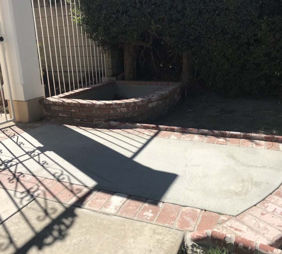 New front yard concrete walkway with brick ribbons and new brick planters. Pacificland Constructors