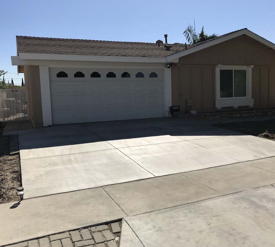 New broom swept concrete driveway with hand scorched joints. Concrete will always crack. These hand scorched joints are intended to control these cracks in a manner that the slab still keeps its cosmetic and structural integrity. Pacificland Constructors