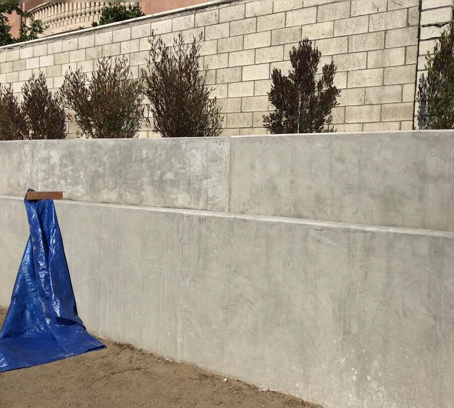 New retaining wall for a backyard in Huntington Beach, CA. This retaining wall creates more flat area for the home because it holds up the differential earth elevation from the neighbor’s home. Pacificland Constructors