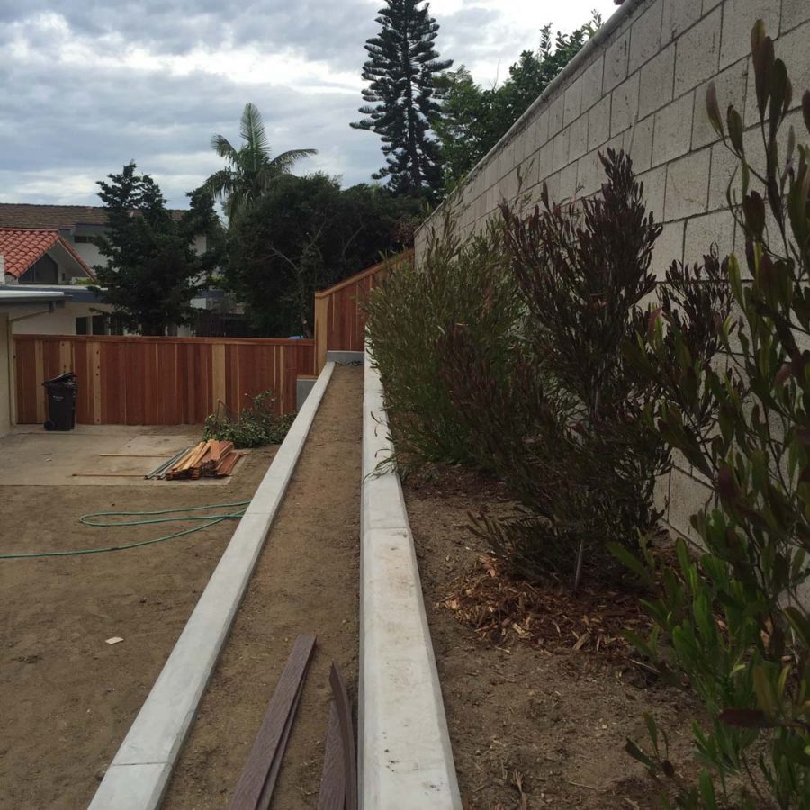 New pour in place concrete retaining wall for a backyard in Huntington Beach, CA. This retaining wall creates more flat area for the home because it holds up the differential earth elevation from the neighbor’s home. It also creates a planter for vegetation. Pacificland Constructors