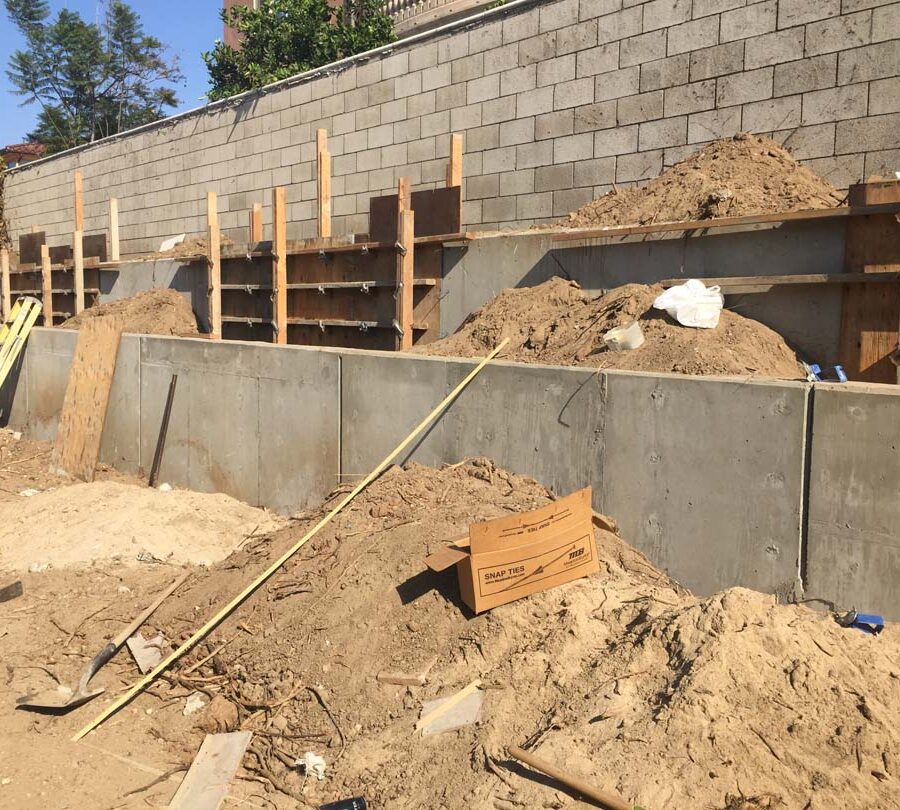 Formwork carpentry and reinforcement for a new concrete retaining wall for a backyard in Huntington Beach, CA. Pacificland Constructors