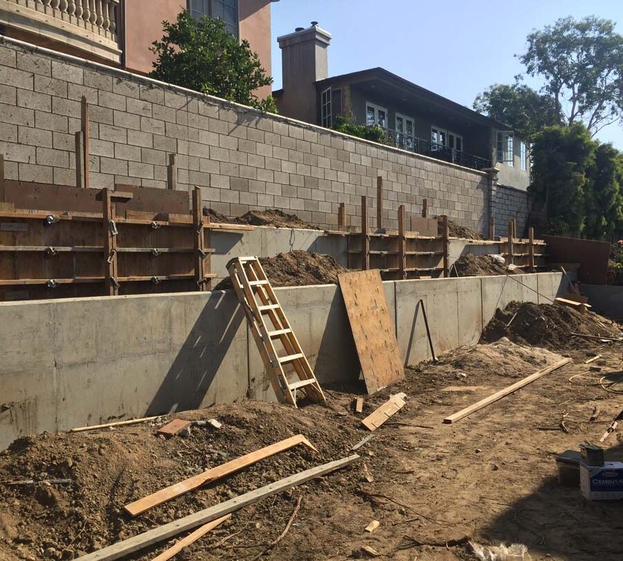 Formwork carpentry and reinforcement for a new concrete retaining wall for a backyard in Huntington Beach, CA. Pacificland Constructors