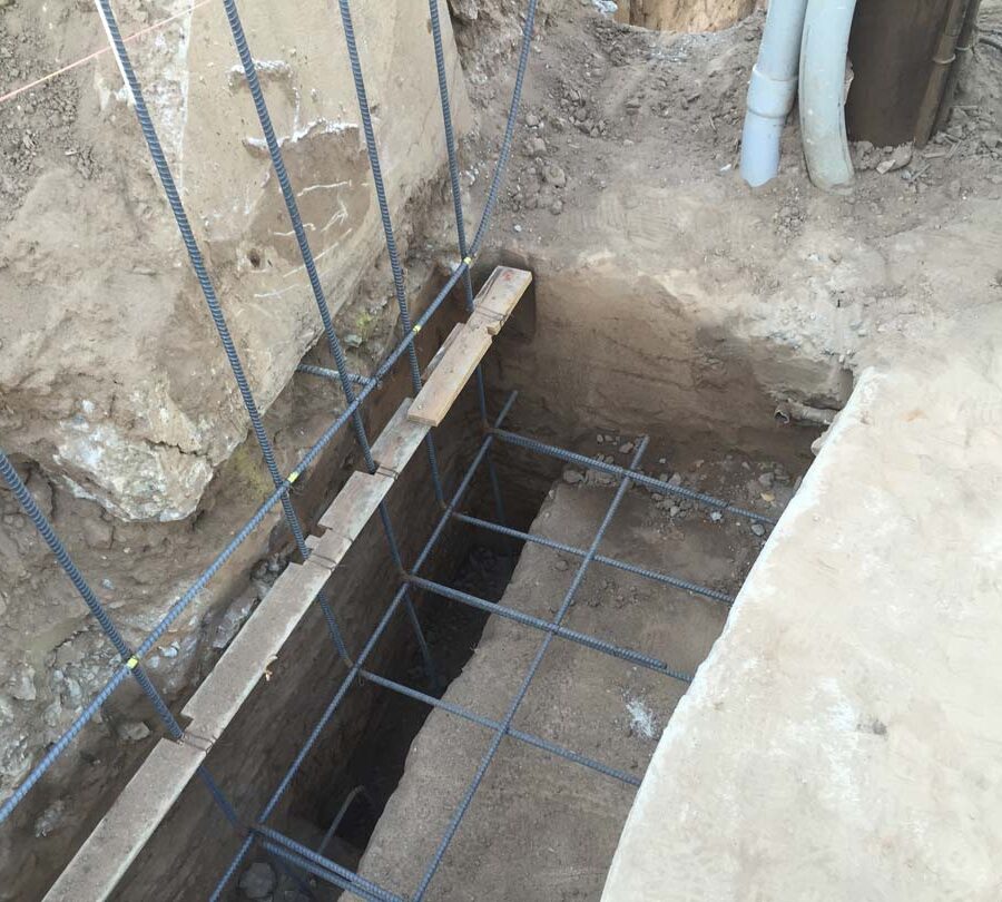 Steel reinforcement of strip footings for a retaining wall after excavating and cleaning them from loose dirt. Pacificland Constructors