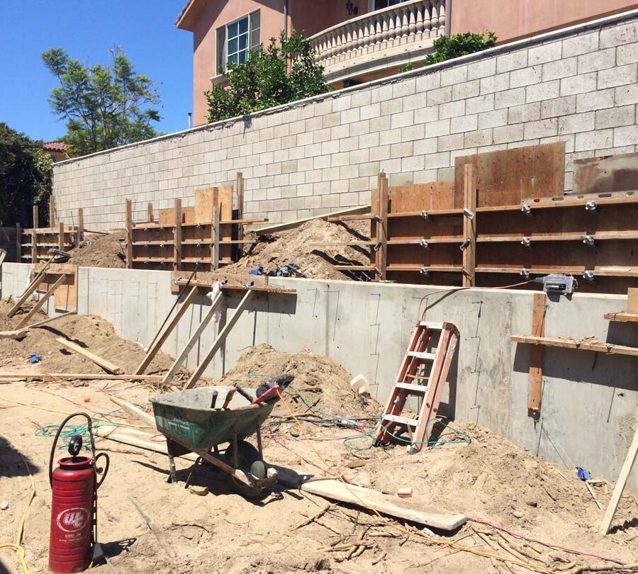 Formwork carpentry and reinforcement for a new concrete retaining wall for a backyard in Huntington Beach, CA.