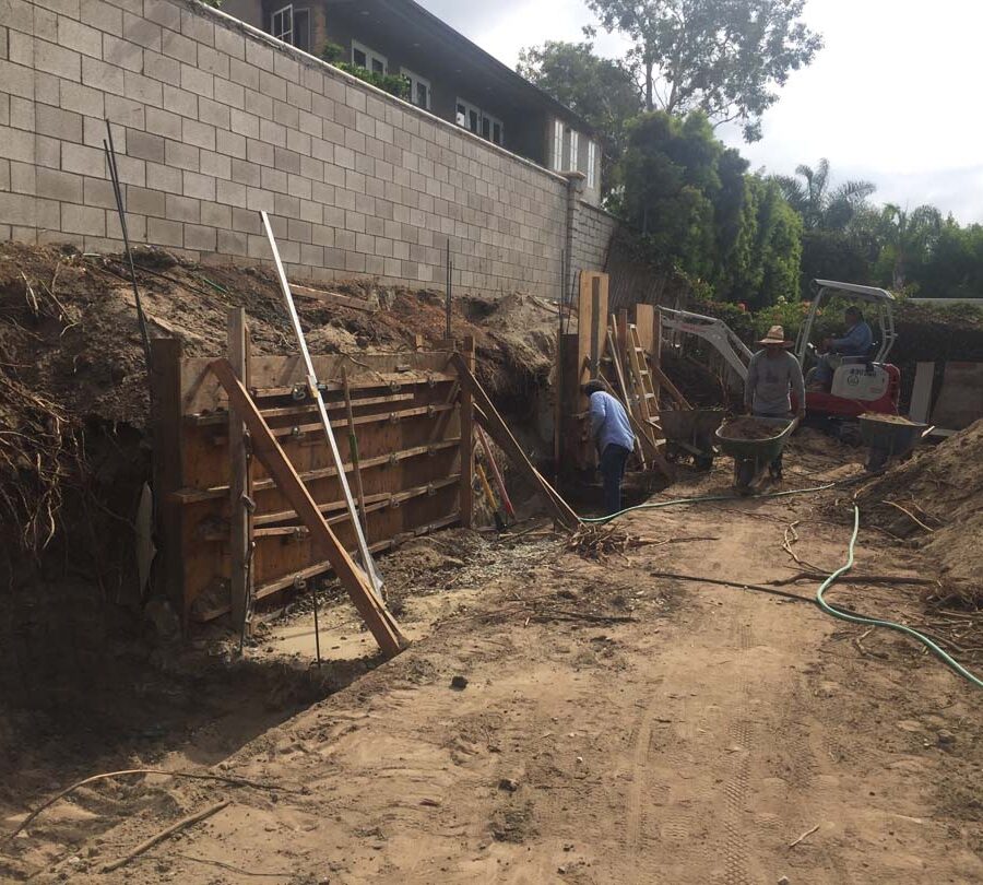 Formwork carpentry and steel reinforcement for a new concrete retaining wall for a backyard in Huntington Beach, CA. Pacificland Constructors