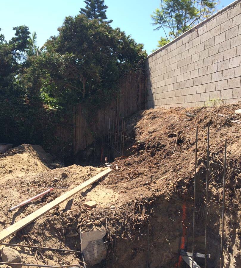 Reinforcement of strip footings with steel ironwork for a new section of concrete retaining wall. Pacificland Constructors