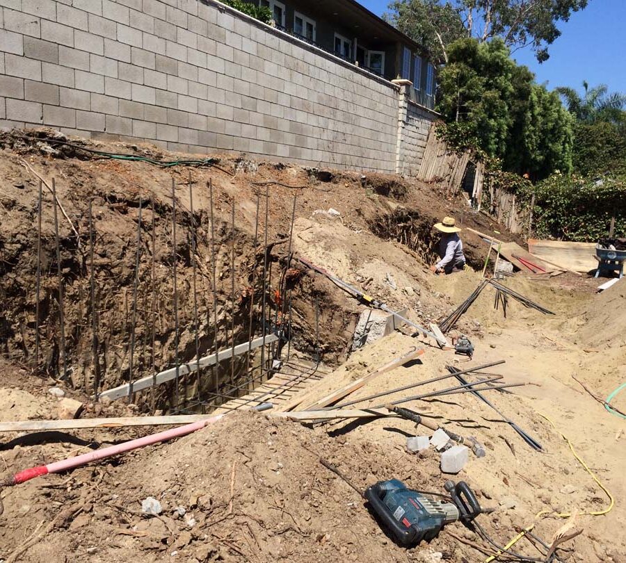 Reinforcement of strip footings with steel ironwork for a new section of concrete retaining wall. Pacificland Constructors