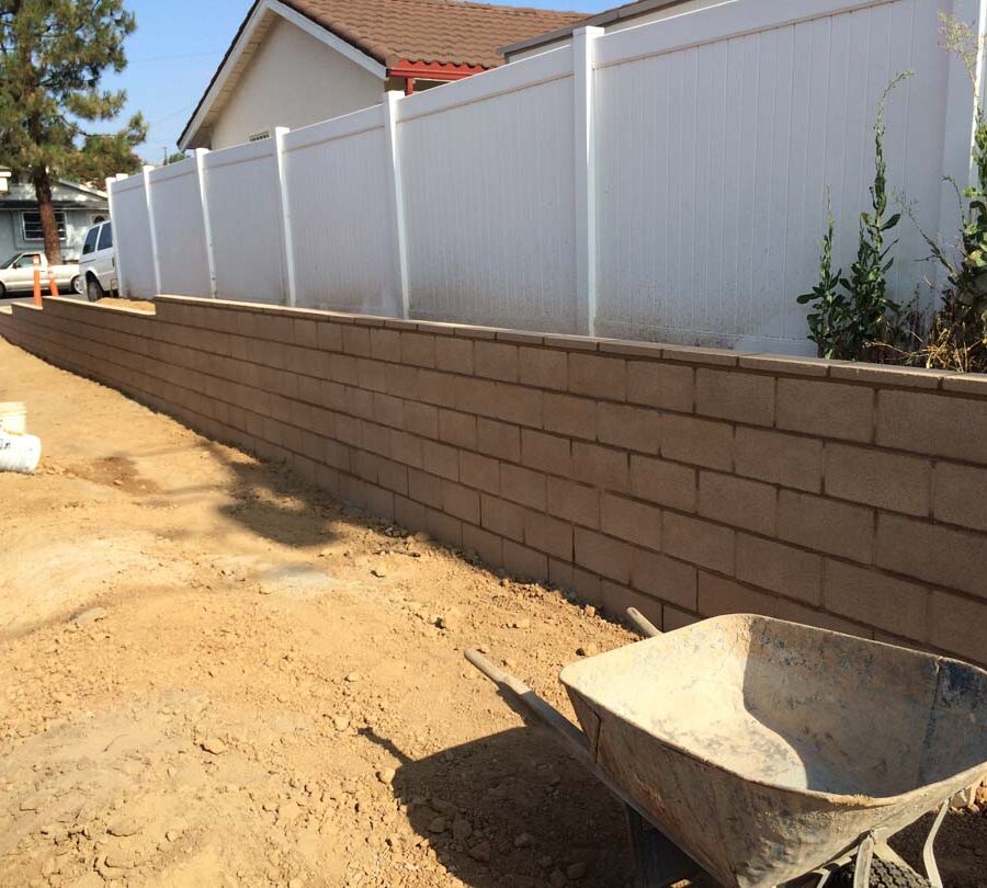 Construction for a new tan precision block retaining wall. Pacificland Constructors