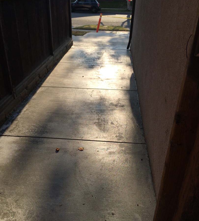 New flatwork concrete at the side of this home allows easy access when taking out the trash from the backyard to the front yard. Pacificland Constructors