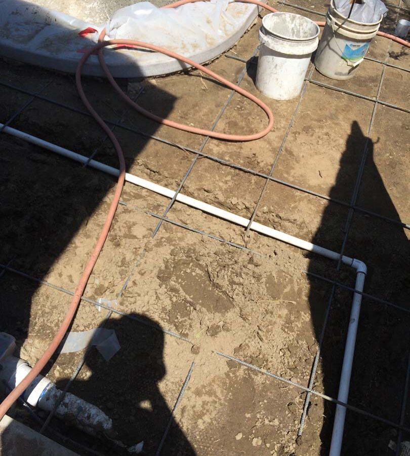 Steel reinforcement and pouring of a new gray concrete deck. We installed a water drainage system to make sure any rainfall or excess water drains out quickly to avoid slipping when using the pool. Pacificland Constructors