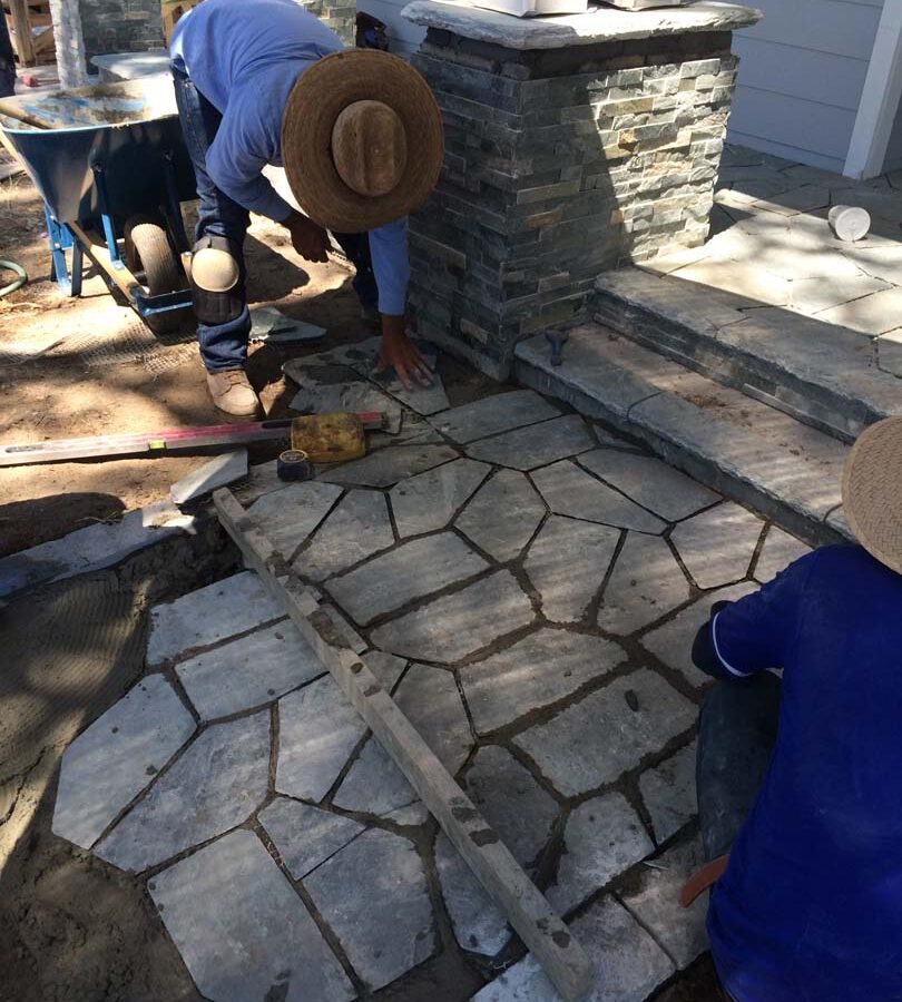 Martin, founder of Pacificland, installing a new flagstone walkway for a home’s front yard’s porch landing. Flagstone work is a great option to raise the value of your home. Pacificland Constructors