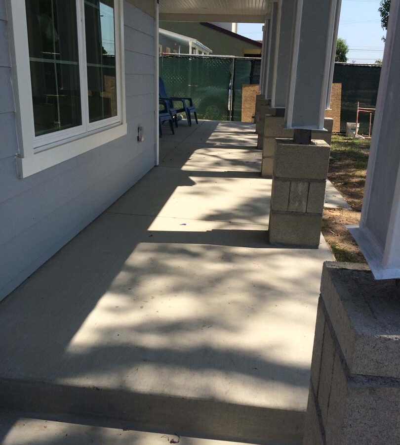 The owner of this home wanted to cover their pilasters at the bottom of each post with stone veneer and install new flagstone over the concrete. We helped them build this upgrade to their home. Pacificland Constructors