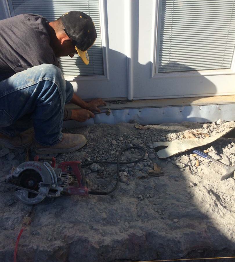 Formwork construction of new concrete porch with steps. Sheathing and flashing is placed to protect the new door that will later be installed. Pacificland Constructors