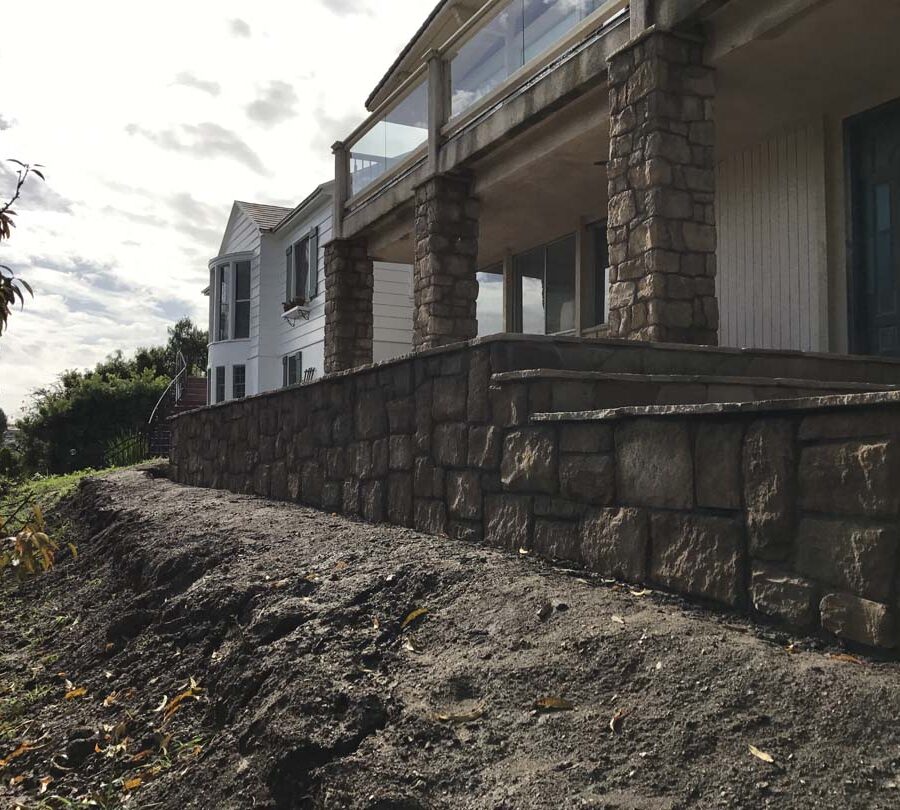 Stone veneered pilasters and walls that match flagstone flatwork for a home’s porch in San Pedro, CA. Pacificland Constructors