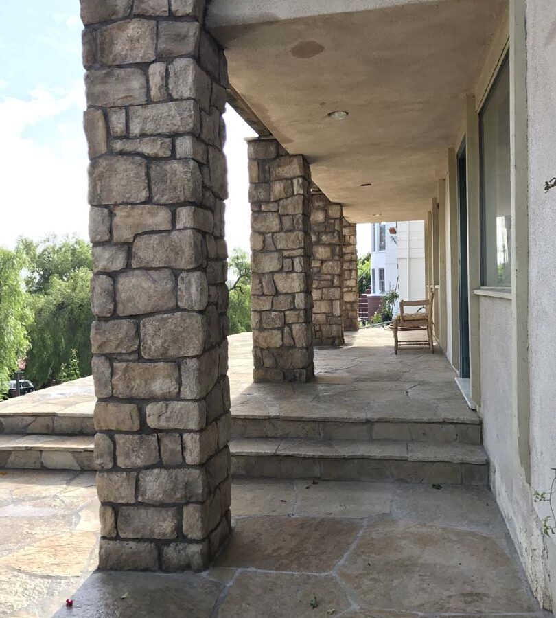 Stone veneered pilasters and walls that match flagstone flatwork for a home’s porch in San Pedro, CA. Pacificland Constructors