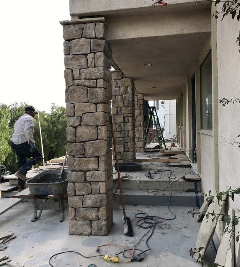 Construction of stone veneered cmu walls and pilasters that will match flagstone flatwork selected by the owner for their home’s porch. Pacificland Constructors