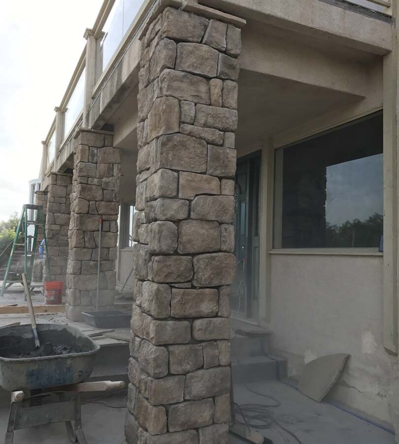 Construction of stone veneered cmu walls and pilasters that will match flagstone flatwork selected by the owner for their home’s porch. Pacificland Constructors