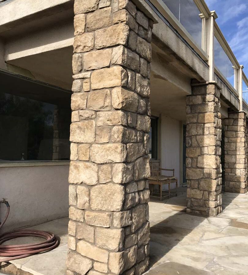 Stone veneered pilasters that match flagstone flatwork. Pacificland Constructors