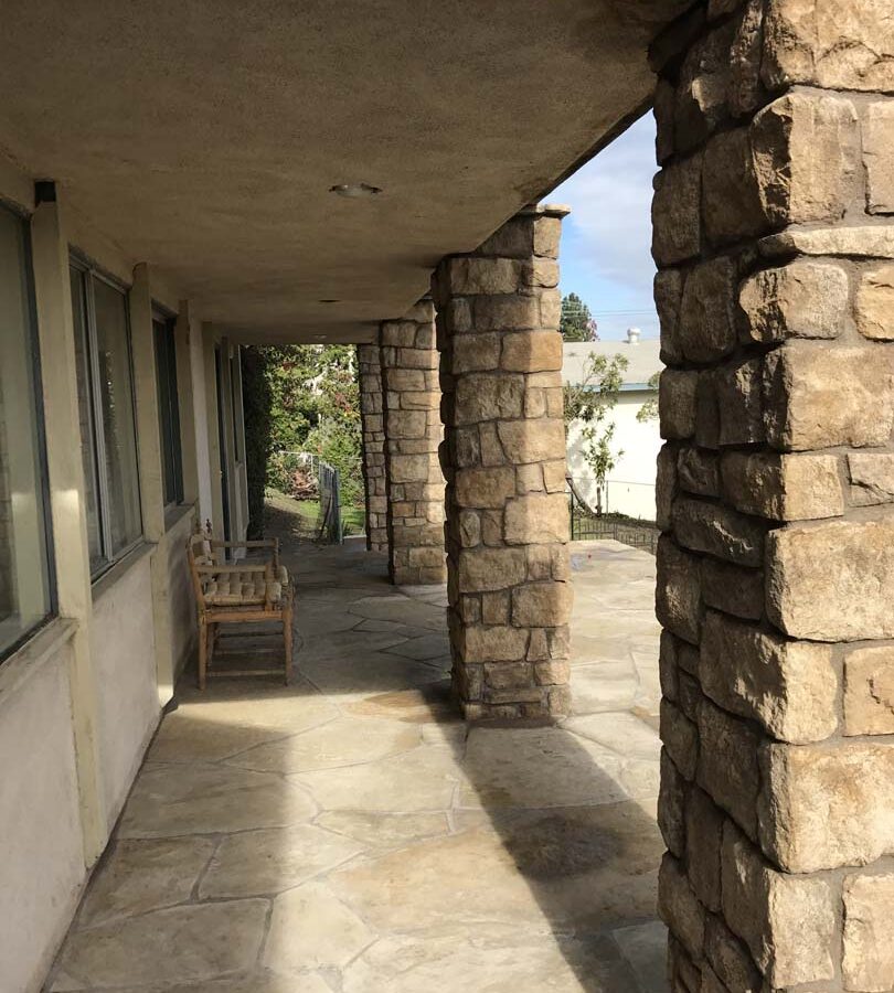 Stone veneered pilasters that match flagstone flatwork. Pacificland Constructors