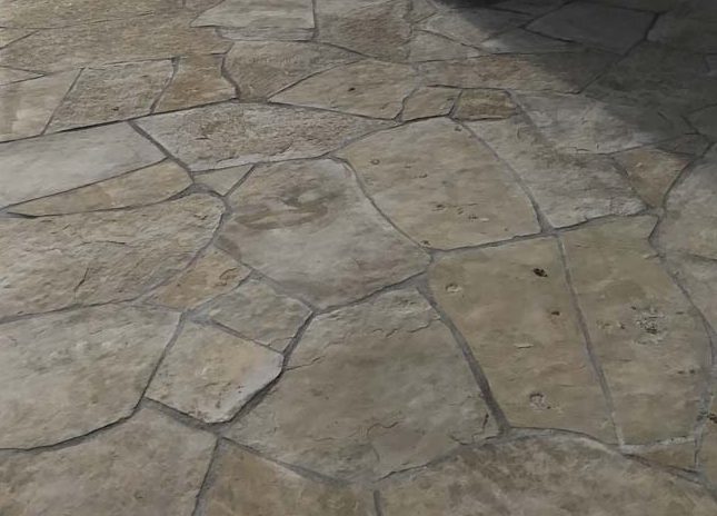 Stone veneered pilasters and walls that match flagstone flatwork. Pacificland Constructors