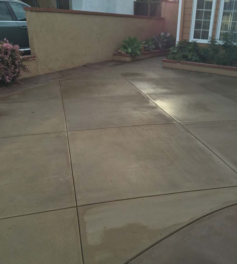 New colored concrete driveway for a residential home. Pacificland Constructors