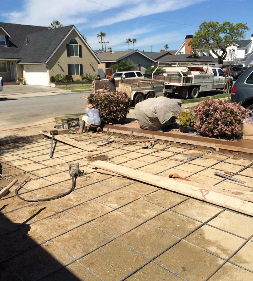 Steel reinforcement for a new colored concrete driveway. It will have a diamond pattern and a contrasting ribbon around the perimeter. The surface will be broom swept and have hand scorched joints. Pacificland Constructors